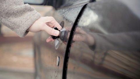 Kiev, Ukraine - January 12,2022: Subaru car door opening with key in rainy weather