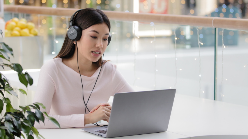  Asian woman worker manager female korean agent help line consultant girl in headset microphone at office cafe table e-learning online mentor business teacher studying talking support service operator | Shutterstock HD Video #1088289057