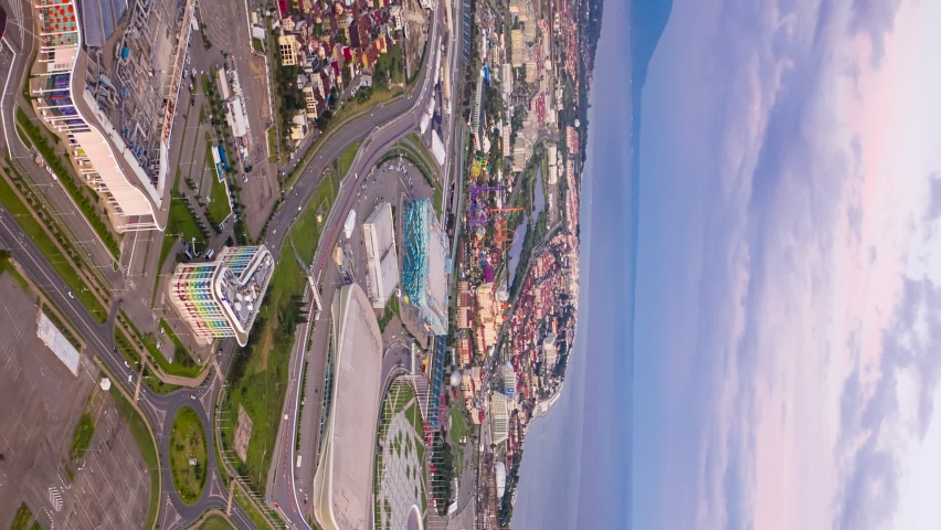 Vertical video. Sochi, Russia - September 5, 2021: Sochi Park. Day-night transition. Turn on night illumination. Bowl of the Olympic flame, Fisht Arena, Sochi Autodrom track and more, Aerial View Hyp
