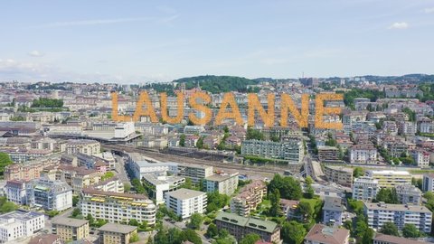 Inscription on video. Lausanne, Switzerland. Flight over the central part of the city. La Cite is a district historical centre. Appears from the sand, Aerial View