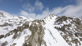 Rocky mountains covered with snow, Pyrenees. Andorra. Aerial fpv