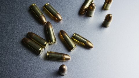 Isolated bullets on a metallic table background, projectile ammo ammunition top down shot