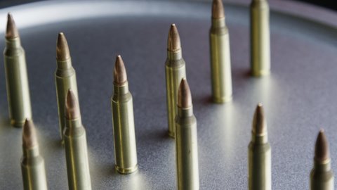 Riffle bullets arranged on a metallic table, ammo and ammunition background concept, munitions isolated