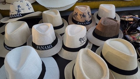 PANAMA MAR 13, 2022, Handmade classic style Panama Hat or sombrero with country name on the band at the traditional outdoor market in Panama. Popular souvenir from Panama