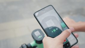 Selective Focus of young man scanning qr code with his phone for electric scooter renting.Young man unlock an e-scooter with mobile phone.Concept of renting an electric scooter in a city - Powered by Shutterstock - Get 15% off with code: PIKWIZARD15