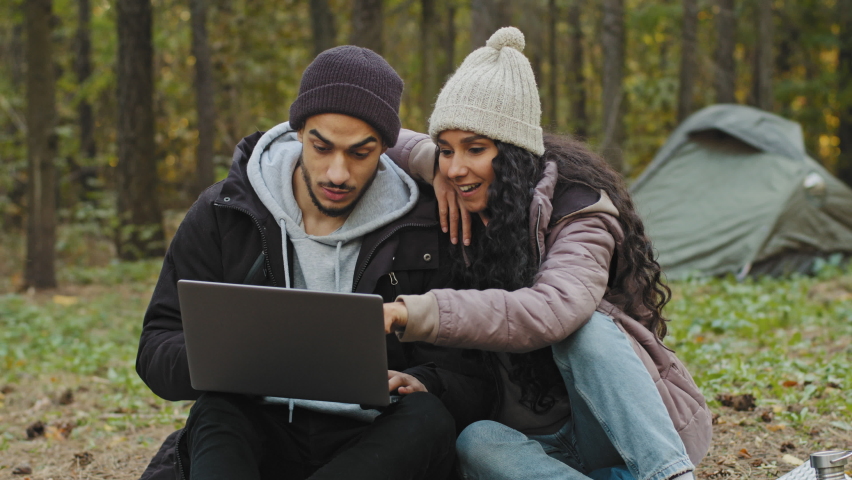 Young excited happy family couple in love sitting in nature reading good news on laptop surprised rejoicing at victory hugging laughing smiling celebrating success winning lottery winner winning prize Royalty-Free Stock Footage #1088298007