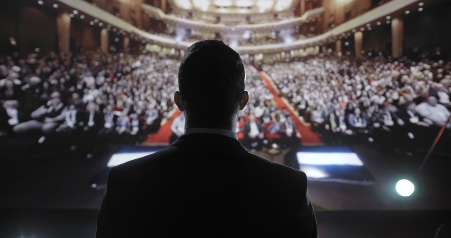 Confident Successful Man On Stage Applauded at Large Business Tech Corporate Conference Success Enterpreneur Charisma Financial CEO UHD 4K Royalty-Free Stock Footage #1088301345