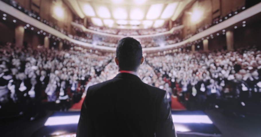 Young Political Tech Mogul Speaking at Large Crowd Business Corporate Conference Applause Success Charisma Financial CEO UHD 4K Royalty-Free Stock Footage #1088301361