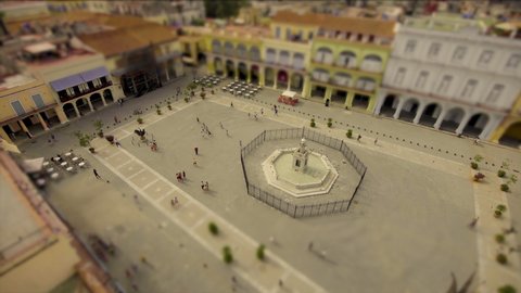 Stop motion, high rise view of people and families walking in a town square. Tilt and Shift.
