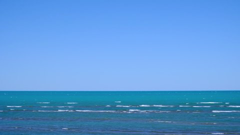 Beautiful lake with waves and clear blue sky. Wind on Balkhash lake. Travel, tourism in Kazakhstan concept. Natural seascape. Beautiful summer landscape. Wild beach.