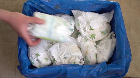 Dirty baby diapers in the trash. Disposing of used nappies. The problem of environmental pollution with disposable plastic products. Disposable Nappy Pollution