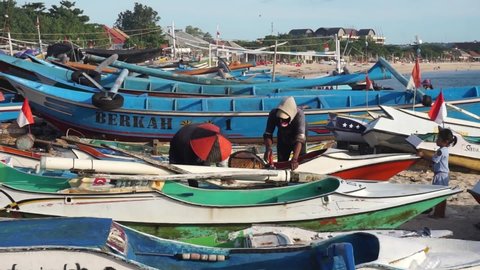 Kedonganan, Bali, Indonesia - March 15, 2022: Fishermen are repairing fishing boats.
