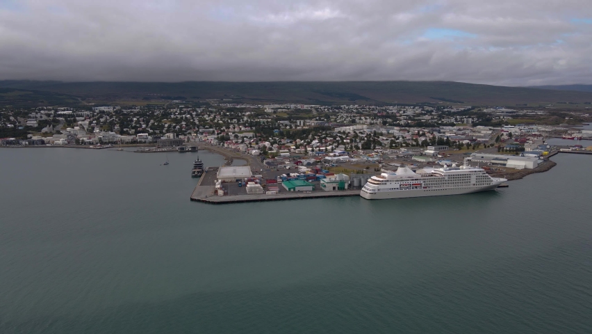 Beautiful aerial cinematic view of Akureyri, a city at the base of Eyjafjörður Fjord in northern Iceland