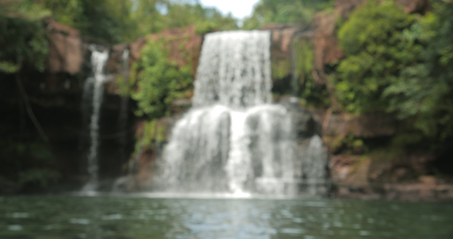 Waterfall in blurred for background. Klong Chao waterfall on koh kood island Trat Thailand. Koh Kood, also known as Ko Kut, is an island in the Gulf of Thailand Royalty-Free Stock Footage #1088309157