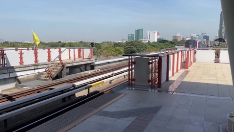 BANGKOK, THAILAND - Circa November, 2021: BTS Skytrain Public Transport arriving Mo Chit Station, interchange station to Chatuchak MRT subway. Beautiful skyline and building in background