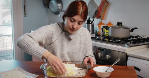 Young Italian girl preparing the dough for homemade potato gnocchi