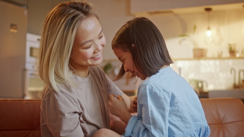 Happy Asian Cute Affectionate Adopted Little Kid Girl Hugging Foster Care Parent Mother with Eyes Closed, Adorable Small Child Daughter Embrace Mum Cuddling Enjoy Tender Sweet Moment Concept Royalty-Free Stock Footage #1088315513