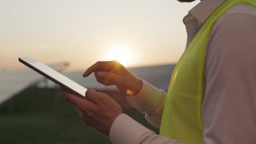 Close up of caucasian male worker tapping with finger on tablet screen during inspection of solar station. Concept of people, gadgets and alternative energy. - Powered by Shutterstock - Get 15% off with code: PIKWIZARD15