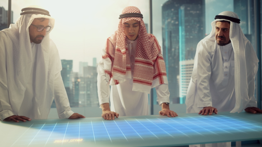 Group of Muslim Real Estate Business Developers in Traditional Clothes Discuss Investing Opportunities Based on Holographic Augmented Reality 3D City Model in Their Modern Office in a Skyscraper. Royalty-Free Stock Footage #1088317905