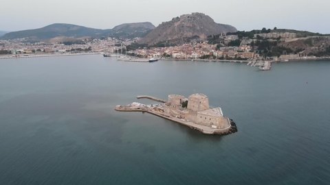 Aerial drone video of venetian castle in front of Palamidi fortress in Nafplio town, Argolida, Greece