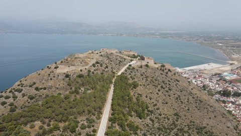 Aerial drone video of medieval Venetian fortress of Palamidi built uphill in historic greek town of Nafplio, Greece, Europe