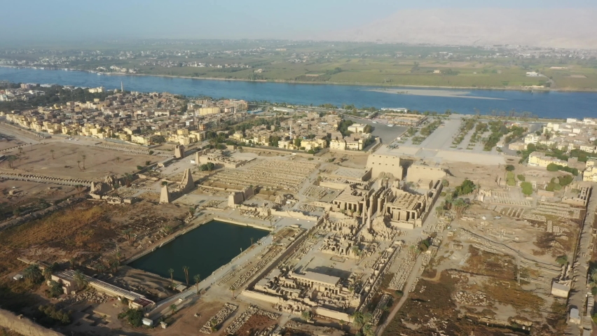 Aerial Drone Zoom in shot of Karnak Temple overlooking the Nile in Luxor, Egypt