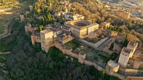 Aerial view of Alhambra Palace in Granada, Andalusia, Spain. Flying over famous Alhambra palace and fortress at sunset. 4K