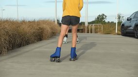 portrait of young child or teen girl roller skating outdoors, fitness, wellbeing, active healthy lifestyle. 