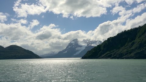 Opening view from tourist ship to mountains with glaciers in Torres del Paine National Park, Chilean Patagonia