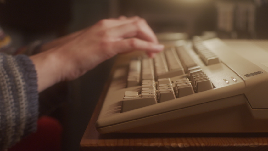 Hands typing on the keyboard of an old  micro computer. Close-up. Royalty-Free Stock Footage #1088322289