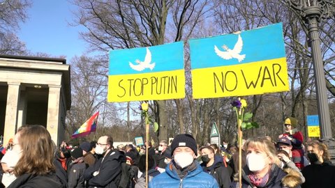 Berlin, Germany - 02-27-2022: Anti war, Protests against war in Ukraine, Russian invasion conflict, Protesters holding signs
