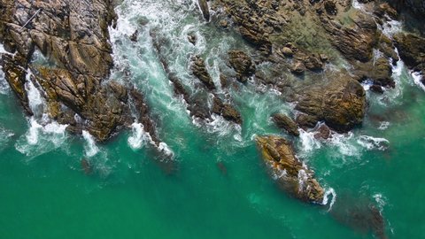 Aerial view of drone. Scene of top view Rock beach and seawater on beach rock in summer. Nature and travel concept.