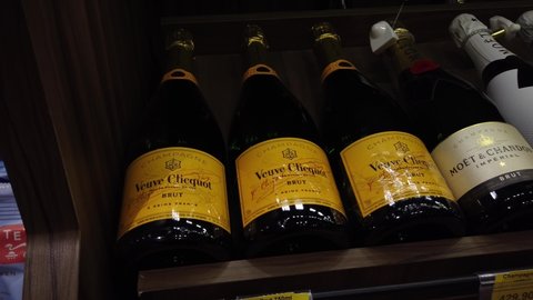Teresopolis, RJ, Brazil - March 17th 2022 - Veuve Clicquot and Moet Chandon champagne prosecco bottles at a market shelf. Party and celebration alcoholic drinks. Bottles laid down.
