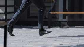 Confident man running city street in suit. Male legs in black shoes closeup. Unrecognized financial manager walk to important business meeting in downtown area. Morning routine in office district. - Powered by Shutterstock - Get 15% off with code: PIKWIZARD15