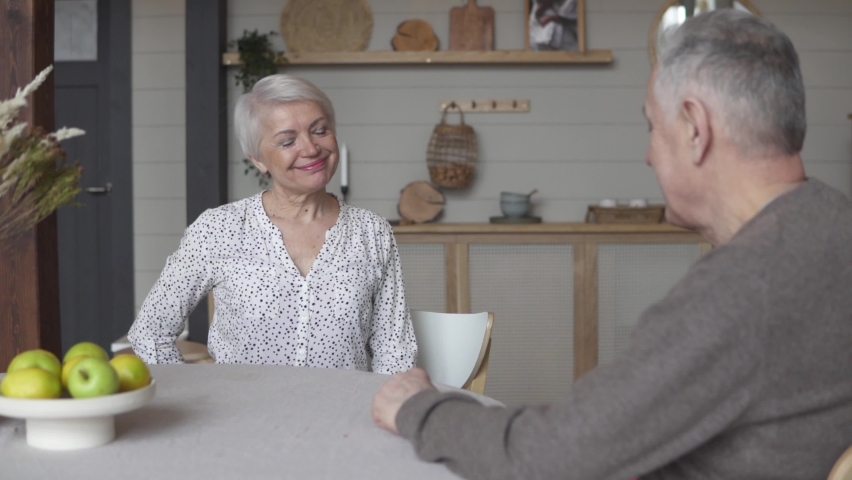 Happily married couple give each other their red hearts in a cozy country house