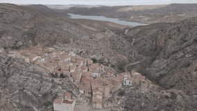
4k video on the narrows of the River Martín with the town of Alcaine in the background and a landscape of pine trees and valleys in the province of Teruel, Aragon. Spain.
