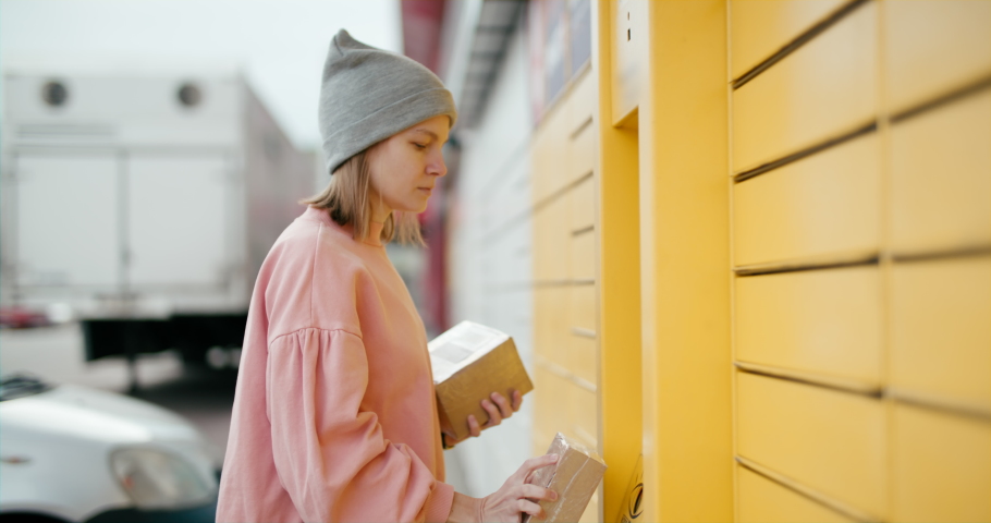 Woman Skans Bar Code and Put Parcel into Locker Cell to Send, Return or Deliver Box. Modern Shipping and Internet Shopping. Customer Uses Selfservice Contactless Automated Postal Box. 6K handheld shot