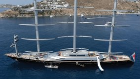 Aerial drone video of massive iconic Super Yacht Maltese Falcon sail boat anchored in Mykonos island in Greece