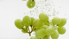 Bunches of Green Grape Falling into Water in Slow Motion on White Background Isolated. Sweet Fruits Splashing into Clear Water. Healthy Food Concept. Macro - Powered by Shutterstock - Get 15% off with code: PIKWIZARD15