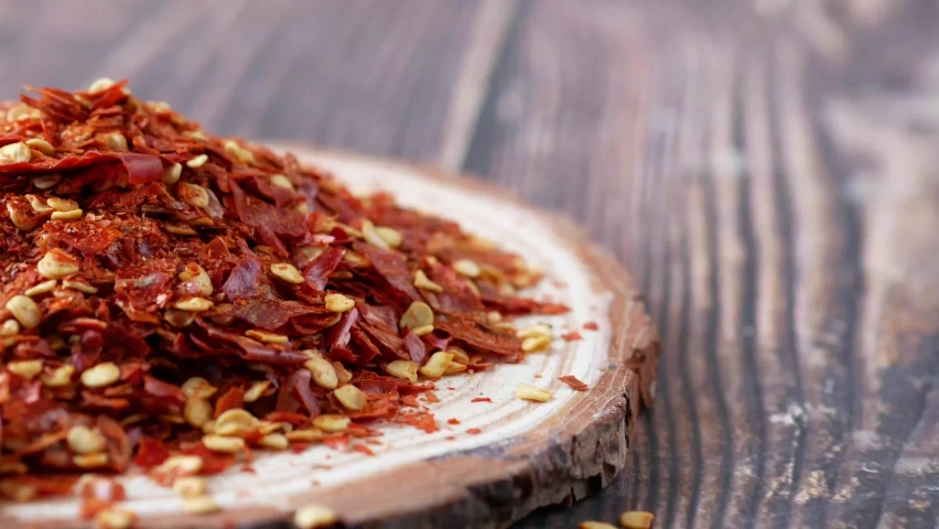 close up of red chili flakes on table 