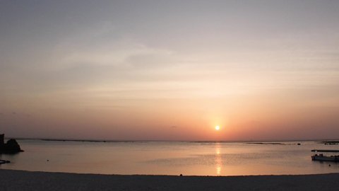 CHTAN-CHO, OKINAWA, JAPAN - AUG 2021 : View of Araha beach (Ocean or sea) in sunset time. Wide view, long time lapse shot, dusk to night. Summer holiday, vacation and resort concept shot.
