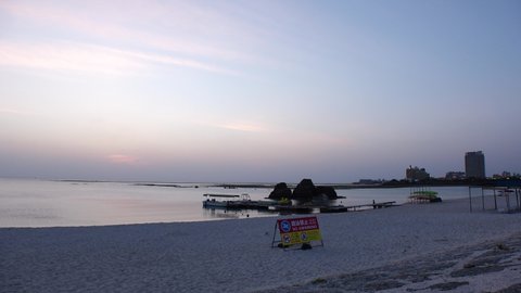 CHTAN-CHO, OKINAWA, JAPAN - AUGUST 2021 : View of Araha beach (Ocean or sea) in dusk. Sunset sky and sea. Romantic summer holiday, vacation and resort concept video.