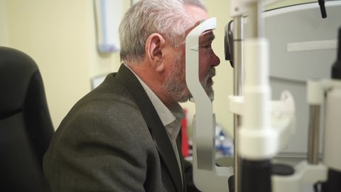 examination of the elderly man on the corneal topographer. Videokeratograph is medical device for determining curvature of cornea. mandatory device for modern clinic or opticians shop.