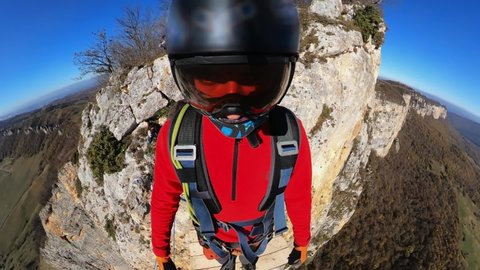 rope jumping, a man jumps from a cliff, free fall, a man falls from a height, helmet camera