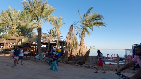 Dahab , Egypt - 02 09 2022: Local People Walking Along Dahab Seaside Street Stalls With Palm Tree Coastline In Egypt In Morning Light