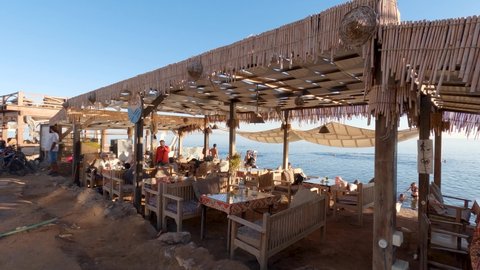 Dahab , Egypt - 02 09 2022: Typical seafront restaurant, Dahab in Egypt. Handheld