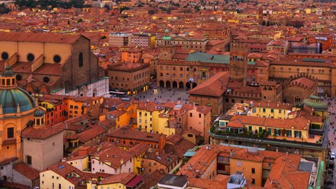 Bologna, Italy. Aerial view of Bologna, Italy at sunset. Colorful sky over the historical city center with car traffic and old buildings. Time-lapse, zoom in