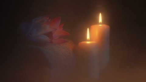 Candles By Towel And Flowers In Sauna