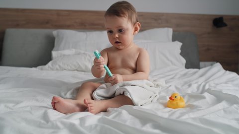 Video of cute caucasian baby brushing a teeth at home. Shot with RED helium camera in 8K.