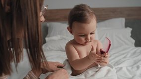 Video of mom and daughter start brushing hair. Shot with RED helium camera in 8K.